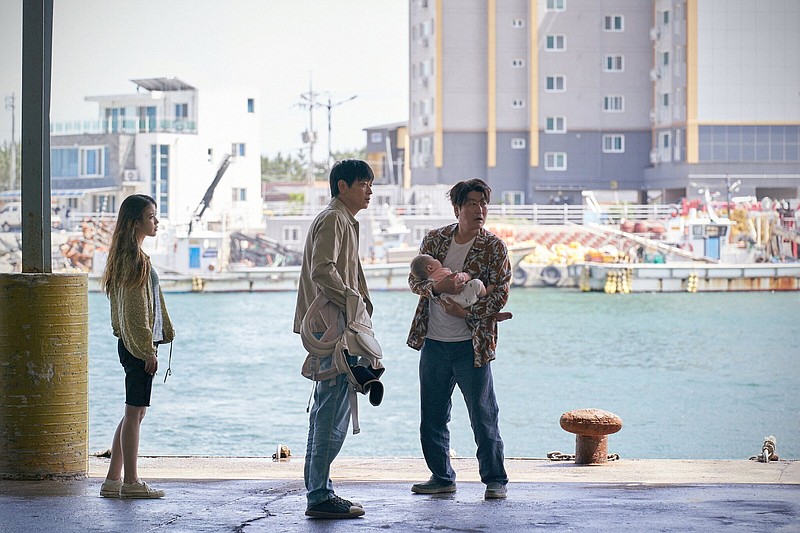 Flesh peddlers So-young (Ji-eun Lee), Dong-soo (Dong-won Gang) and Sang-hyeon (Song Kang-ho) look to move some precious cargo in South Korean auteur Hirokazu Koreeda’s “Broker.”