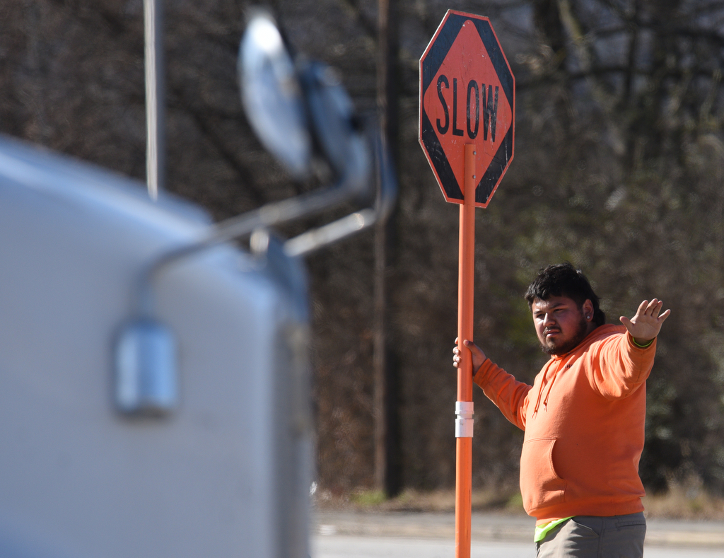 Staff photo by Matt Hamilton / A worker pauses traffic as a cement truck brings cement as construction continues on the onramp between Market Street and I-24 on Thursday, January 19, 2023. The contractor, Charleston, Tennessee-based Wright Brothers Construction, this week has been working on new bridge construction, storm drainage structures and utility relocation in the ongoing I-24 interchange improvement project in Chattanooga, according to the Tennessee Department of Transportation. The project is expected to be finished by the end of August.