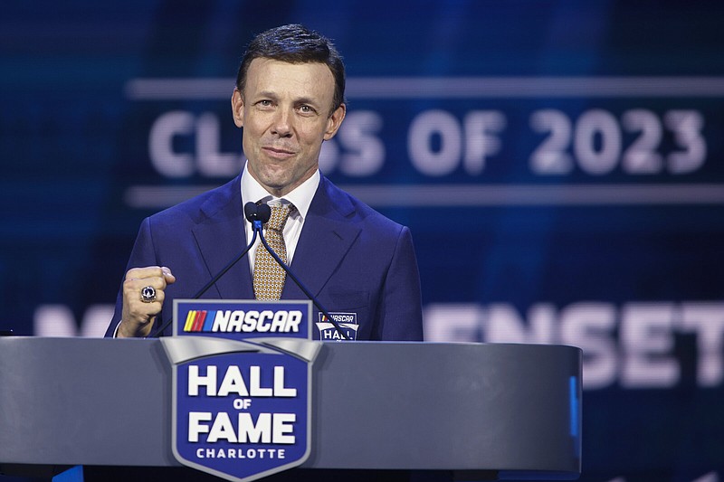 Matt Kenseth shows his ring as he speaks during his induction into the NASCAR Hall of Fame in Charlotte, N.C., Friday, Jan. 20, 2023. (AP Photo/Nell Redmond)