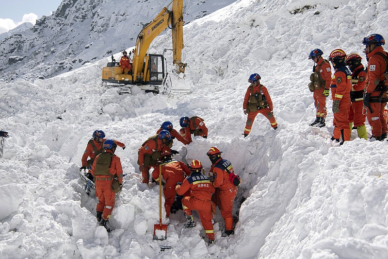 Rescuers search for survivors following an avalanche Friday in Nyingchi, southwest China’s Tibet Autonomous Region.
(AP/Xinhua/Sun Fei)