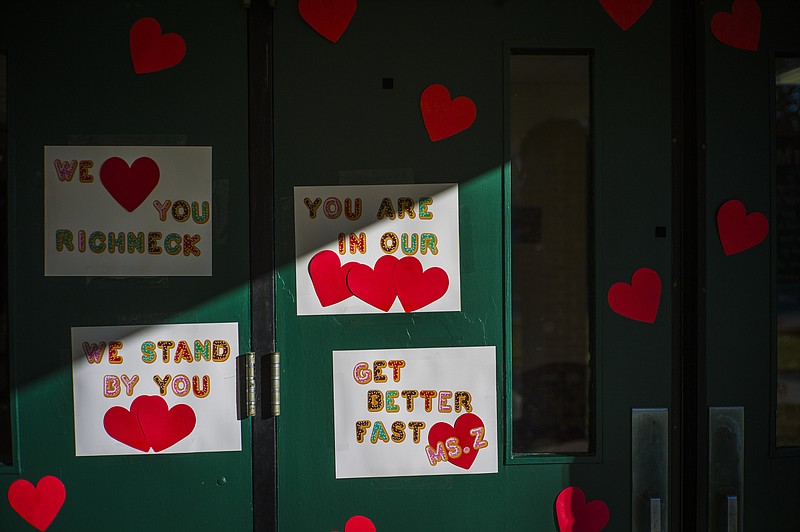 Messages of support for teacher Abby Zwerner, who was shot by a 6 year old student, grace the front door of Richneck Elementary School Newport News, Va. on Monday Jan. 9, 2023. The Virginia teacher who authorities say was shot by a 6-year-old student is known as a hard-working educator who’s devoted to her students and enthusiastic about the profession that runs in her family. (AP Photo/John C. Clark)