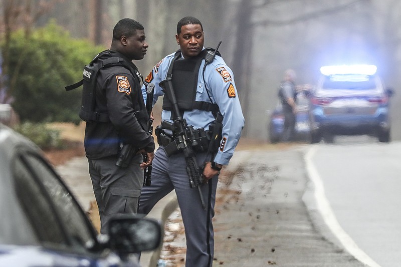 Georgia state troopers stand along Key Road in Atlanta on Wednesday, Jan. 18, 2023. Georgia state troopers helping conduct a "clearing operation" at the site of Atlanta's planned public safety training center exchanged gunfire with a protester Wednesday morning, leaving the protester dead and one trooper wounded, according to the Georgia Bureau of Investigation. (John Spink/Atlanta Journal-Constitution via AP)
