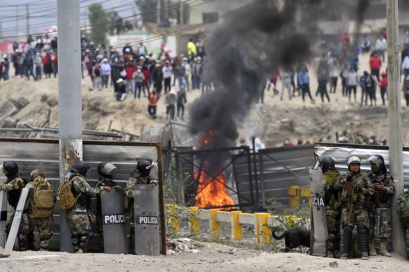 Soldiers clash with anti-government protesters outside the Alfredo Rodriguez Ballon airport in Arequipa, Peru, Friday, Jan. 20, 2023. Protesters are seeking immediate elections, President Dina Boluarte's resignation, the release of ousted President Pedro Castillo and justice for up to 48 protesters killed in clashes with police. (AP Photo/Jose Sotomayor)