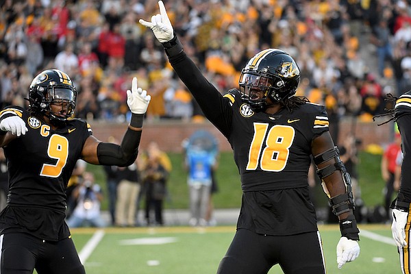 Missouri defensive lineman Trajan Jeffcoat (18) and defensive lineman Isaiah McGuire (9) celebrate during the first half of an NCAA college football game against Georgia Saturday, Oct. 1, 2022, in Columbia, Mo. (AP Photo/L.G. Patterson)