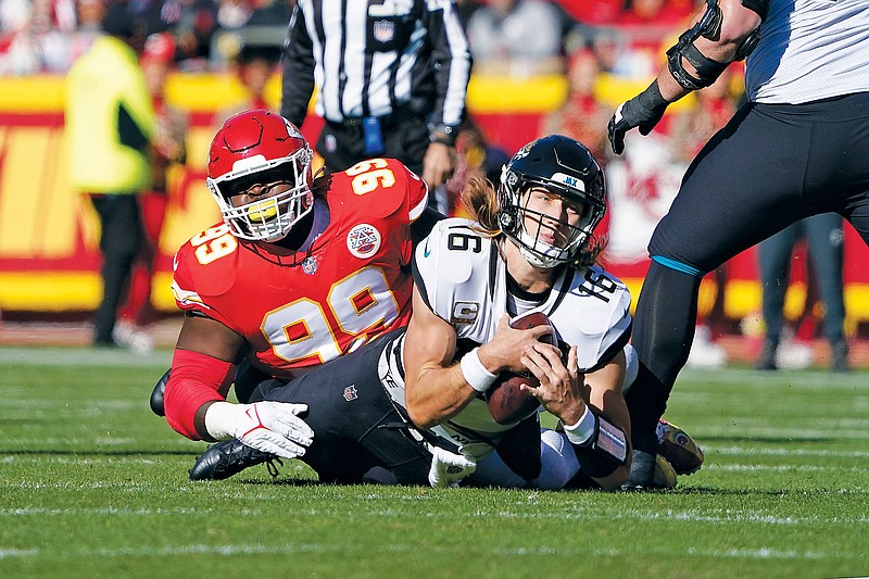In this Nov. 13, 2022, file photo, Jaguars quarterback Trevor Lawrence is tackled by Chiefs defensive tackle Khalen Saunders during a game at Arrowhead Stadium in Kansas City. (Associated Press)