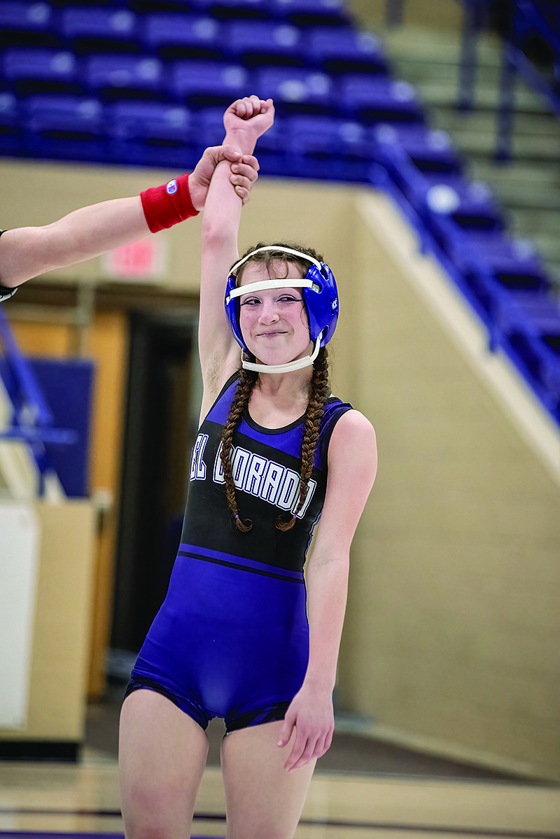 Maddie Aguiluz gets her hand raised in victory after a pin fall win against Evangel.