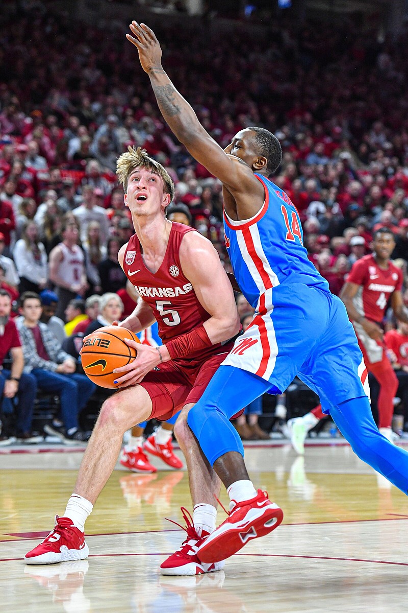 Arkansas guard Joseph Pinion (5) drives as Ole Miss guard Tye Fagan (14) defends, Saturday, Jan. 21, 2023, during the second half of the Razorbacks’ 69-57 win over the Rebels at Bud Walton Arena in Fayetteville. Visit nwaonline.com/photo for today's photo gallery..(NWA Democrat-Gazette/Hank Layton)