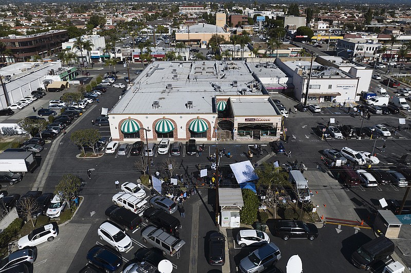 Members of the media are stationed in a parking lot outside Star Dance Studio in Monterey Park, Calif., Monday, Jan. 23, 2023. Authorities searched for a motive for the gunman who killed 10 people at the ballroom dance club during Lunar New Year celebrations, slayings that sent a wave of fear through Asian American communities and cast a shadow over festivities nationwide. (AP Photo/Jae C. Hong)