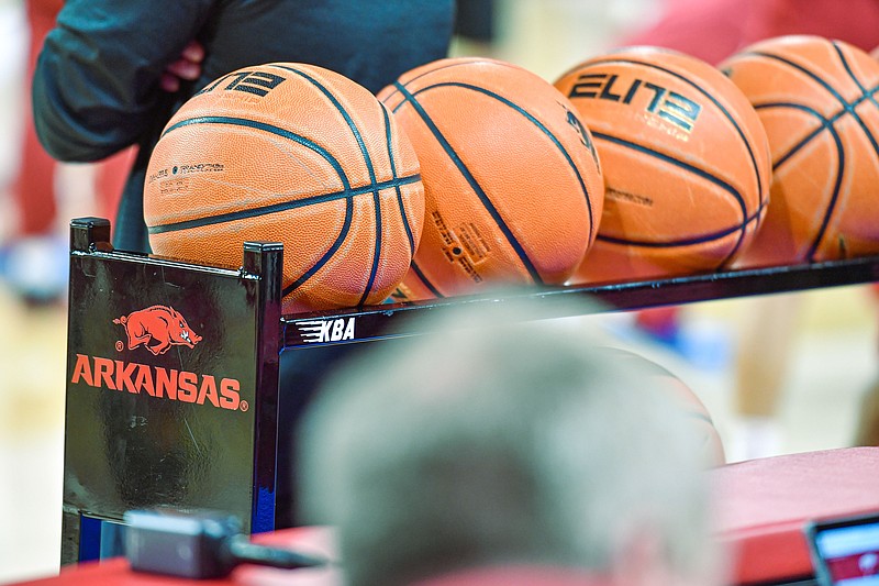 Basketballs rest on a rack with an Arkansas Razorbacks logo, Wednesday, Jan. 11, 2023, before the first half of the Alabama Crimson Tide’s 84-69 win over the Razorbacks at Bud Walton Arena in Fayetteville.