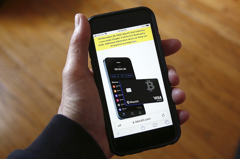 Text, in yellow, announcing cryptocurrency lender BlockFi's bankruptcy filing, appears on the company's website on a smartphone, Nov. 28, 2022, in New York. Over the past few years, a number of companies have attempted to act as the cryptocurrency equivalent of a bank, promising lucrative returns to customers who deposited their bitcoin or other digital assets. In a span of less than 12 months, nearly all of the biggest of those companies have failed spectacularly. (AP Photo/Peter Morgan, File)