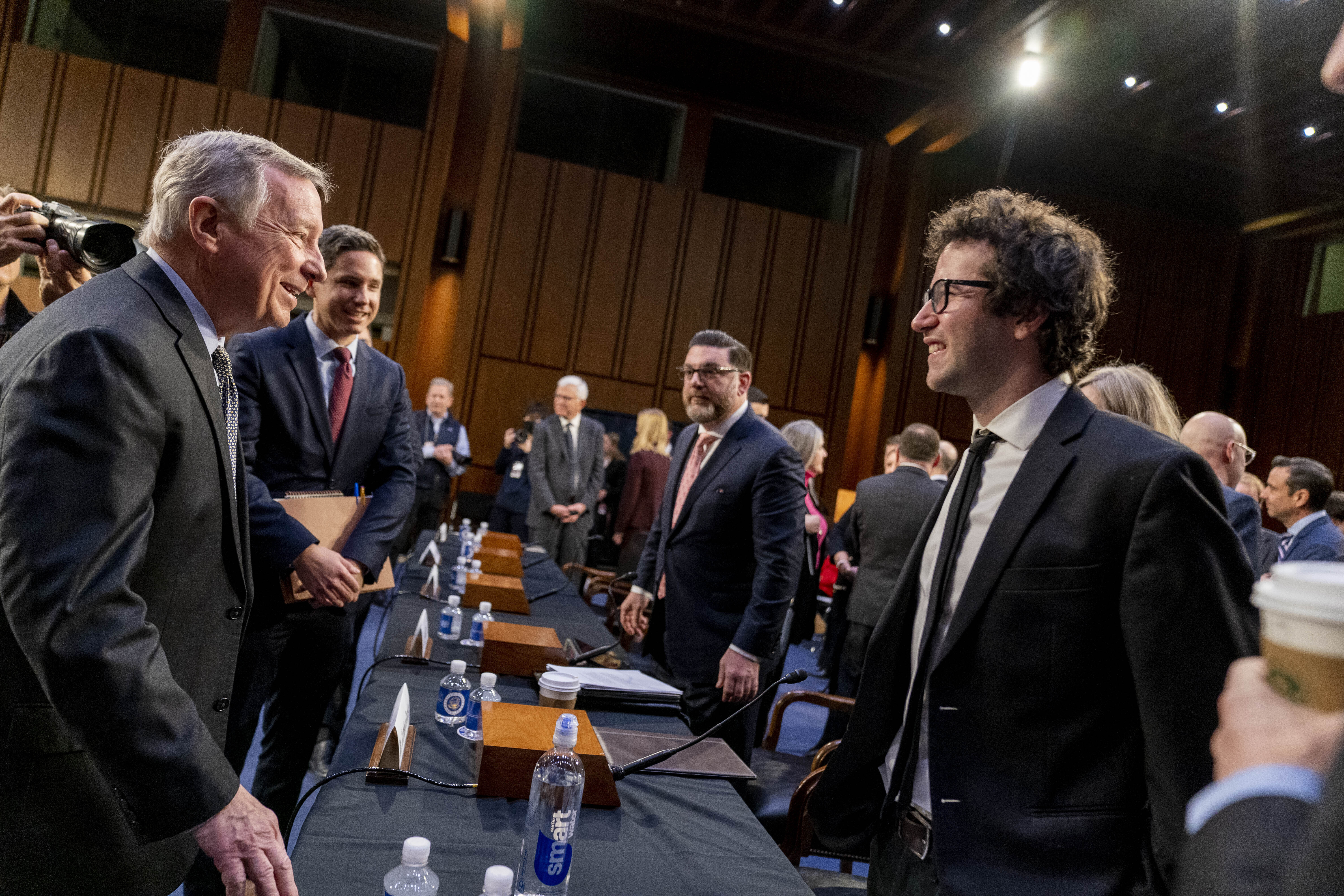 Chairman Sen. Dick Durbin, D-Ill., left, greets singer-songwriter Clyde Lawrence before a Senate Judiciary Committee hearing to examine promoting competition and protecting consumers in live entertainment on Capitol Hill in Washington, Tuesday, Jan. 24, 2023. (AP Photo/Andrew Harnik)