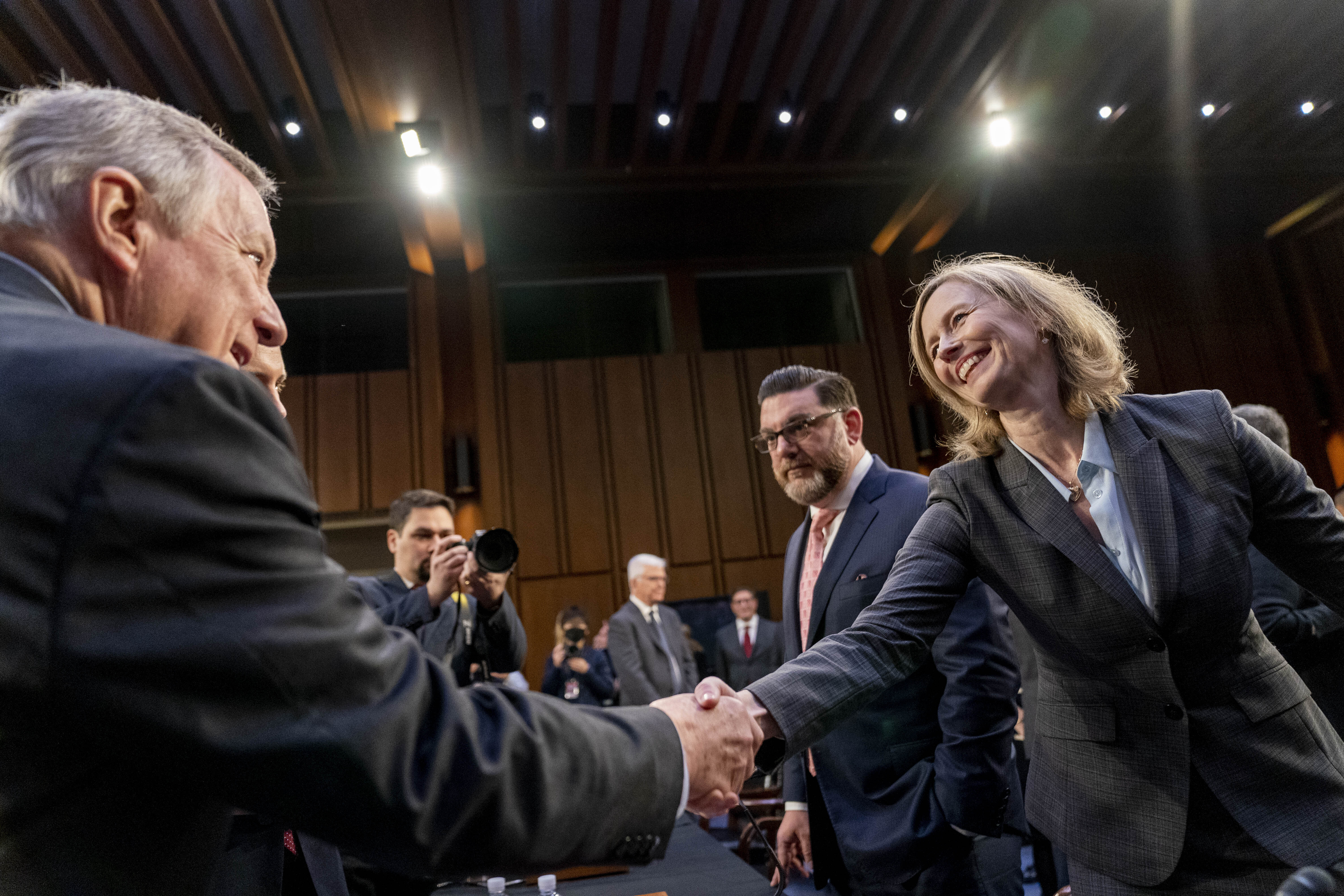 Chairman Sen. Dick Durbin, D-Ill., left, greets The James Madison Institute Senior Vice President Sal Nuzzo, second from right, and American Antitrust Institute Vice President For Legal Advocacy Kathleen Bradish, right, as they appear before a Senate Judiciary Committee hearing to examine promoting competition and protecting consumers in live entertainment on Capitol Hill in Washington, Tuesday, Jan. 24, 2023. (AP Photo/Andrew Harnik)