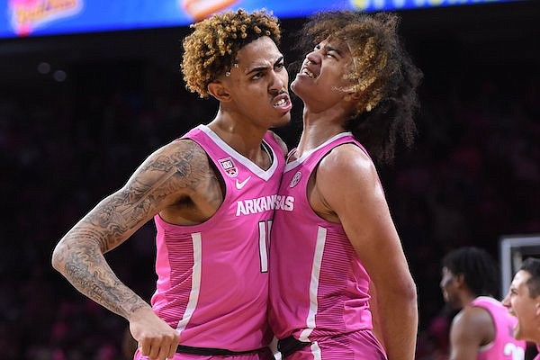 Arkansas forward Jalen Graham (left) and guard Anthony Black celebrate during a game against LSU on Tuesday, Jan. 24, 2023, in Fayetteville.