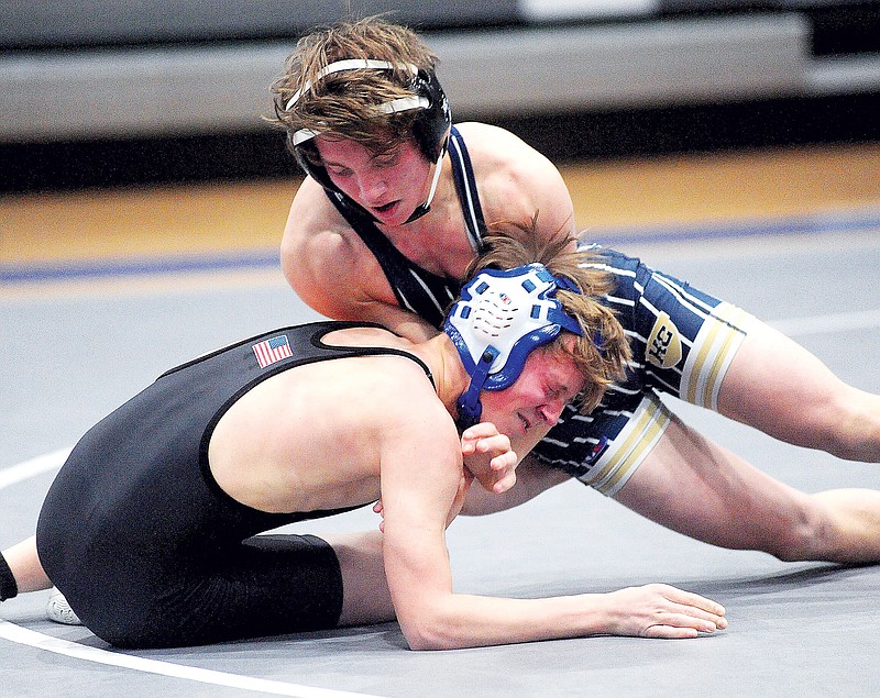 Evan Dunn of Helias works on Brady Hale of Capital City during their 113-pound match Tuesday night at Capital City High School. (Shaun Zimmerman/News Tribune)