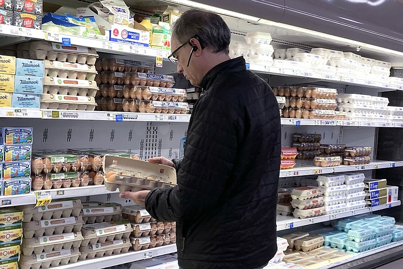 A shopper checks a carton of eggs at a grocery store in Glenview, Ill., on Jan. 10.
(AP/Nam Y. Huh)