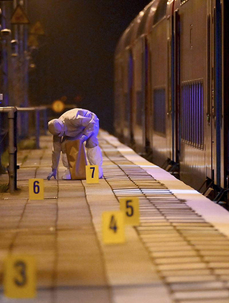 Forensics staff work at a train platform on Wednesday in Brokstedt, Germany.
(AP/dpa/Jonas Walzberg)