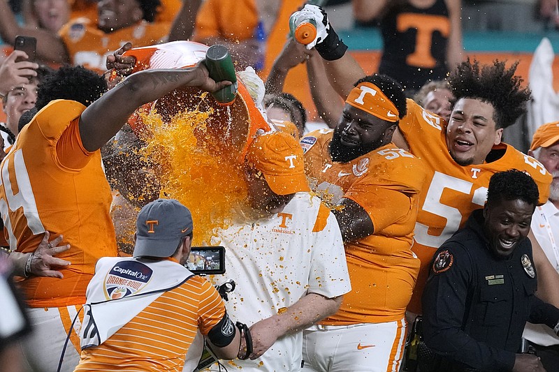 Tennessee coach Josh Heupel gets doused after Tennessee defeated Clemson in the Orange Bowl NCAA college football game, Friday, Dec. 30, 2022, in Miami Gardens, Fla. (Al Diaz/Miami Herald via AP)