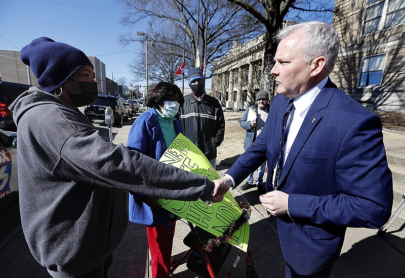 Attorney General Tim Griffin (right) shakes hands with Big Country Chateau apartments resident Clara Edmondson outside Little Rock City Hall on Thursday.
(Arkansas Democrat-Gazette/Thomas Metthe)