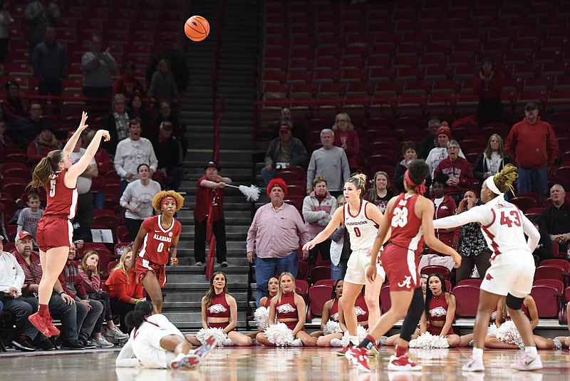 Alabama’s Hannah Barber hits a go-ahead three-pointer with eight seconds remaining during the Crimson Tide’s 69-66 victory over Arkansas on Thursday night at Fayetteville. More photos available at arkansasonline.com/127alaua/.
(NWA Democrat-Gazette/Andy Shupe)