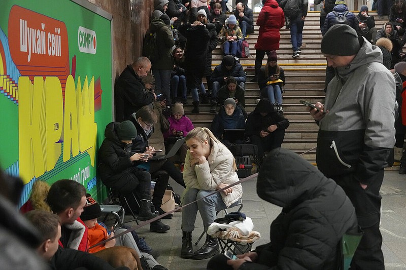 People gather in the subway station being used as a bomb shelter during a rocket attack in Kyiv, Ukraine, Thursday, Jan. 26, 2023. (AP Photo/Efrem Lukatsky)