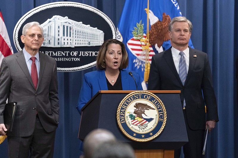 Deputy Attorney General Lisa Monaco flanked by Attorney General Merrick Garland, left, and Federal Bureau of Investigation (FBI) Director Christopher Wray speaks during a news conference to announce an international ransomware enforcement action, at the Department of Justice in Washington, Thursday, Jan. 26, 2023. The FBI has seized the website of a prolific ransomware gang that has heavily targeted hospitals and other healthcare providers. (AP Photo/Jose Luis Magana)