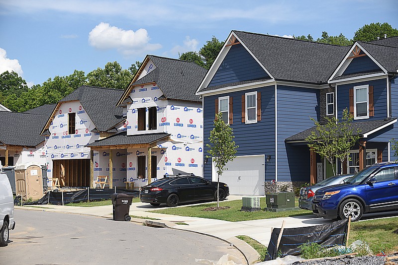 Staff Photo by Matt Hamilton / Finished homes sit next to homes under construction on Highborne Lane in Ooltewah on Wednesday, June 30, 2021.