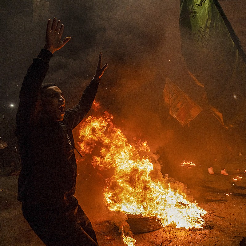 Palestinians celebrate Friday night in Gaza City after a deadly shooting attack at a synagogue in east Jerusalem. Some Gaza residents handed out sweets or honked car horns as calls of “God is great!” blared from mosque speakers.
(AP/Fatima Shbair)