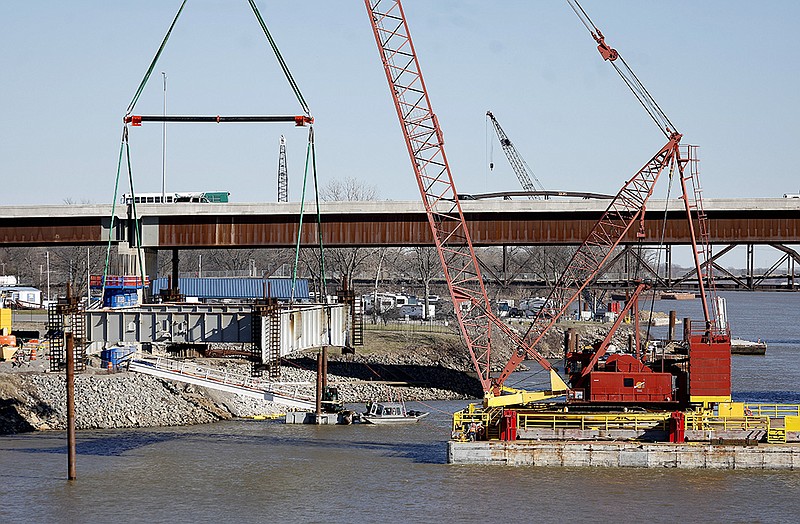 A piece of the old Interstate 30 bridge is moved ashore after it was cut down on Friday, Jan. 27, 2023, as part of the 30 Crossing project. .(Arkansas Democrat-Gazette/Thomas Metthe)