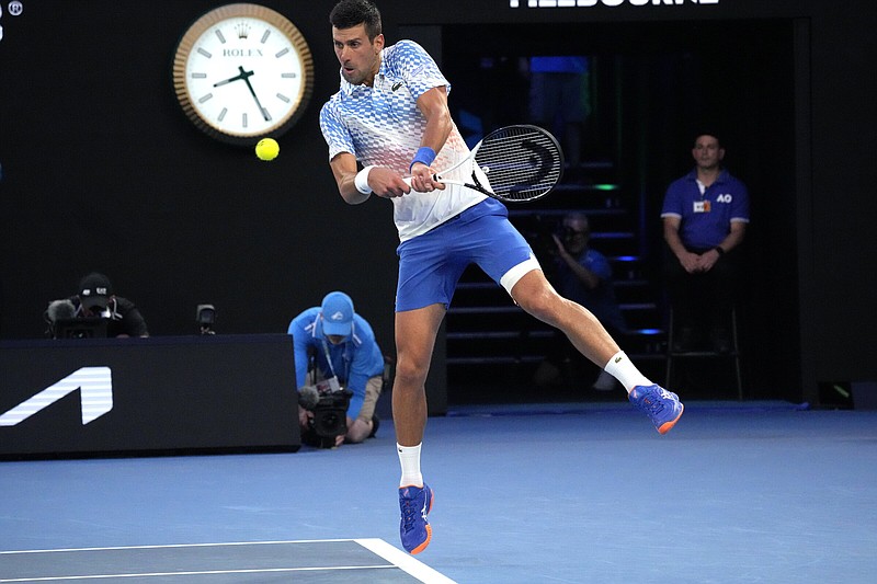 Novak Djokovic of Serbia plays a backhand return to Tommy Paul of the United States during their Australian Open semifinal Friday in Melbourne, Australia. Djokovic won 7-5, 6-1, 6-2 to close in on a 10th Australian Open championship and 22nd Grand Slam title overall.
(AP/Aaron Favila)