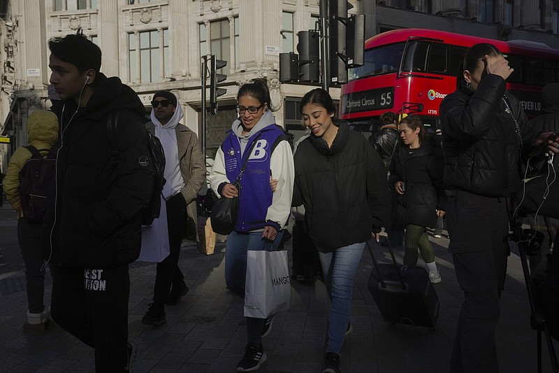 People walk along a street in a shopping district in central London on Jan. 13.
(AP)