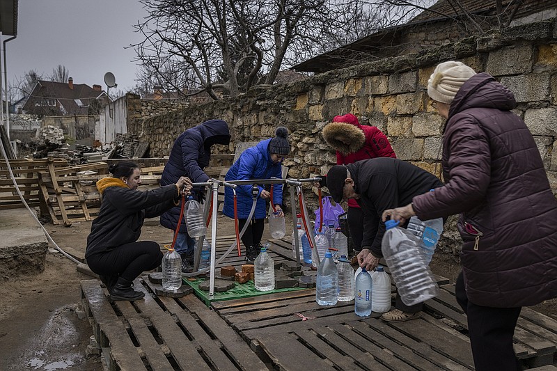 People collect drinking water from a public distribution point Friday in Mykolaiv in the Donetsk region of eastern Ukraine. Russian shelling has killed several civilians in towns and villages along the front lines in Donetsk over the past 24 hours, local officials said Friday.
(The New York Times/Ivor Prickett)