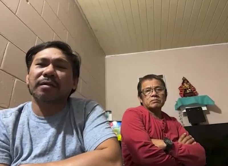 In this image from video, Renato Decena, left, and Rosel Hernandez sit for a video interview with The Associated Press on Sept. 13, 2022. The two are among 10 workers from the Philippines who claim in a federal lawsuit about pay, housing conditions and treatment by a Louisiana-based major offshore oil industry employer in Louisiana. (AP Photo)