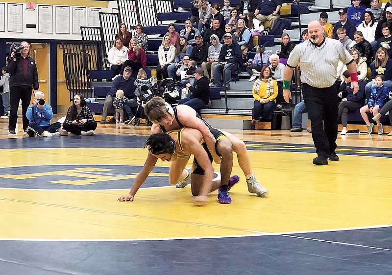 Justin Wieberg of Helias holds down Marion Cole of Sedalia Smith-Cotton in their 132-pound match Thursday at Rackers Fieldhouse. (Tom Rackers/News Tribune)