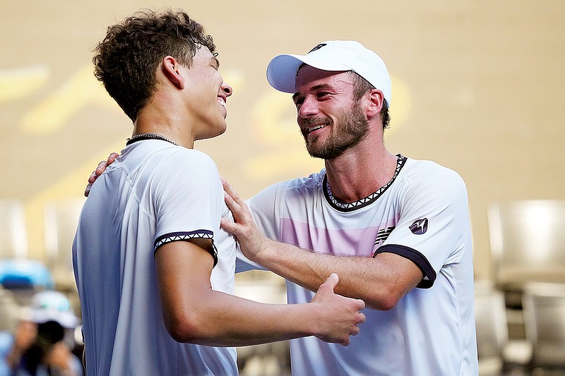 Tommy Paul (right) is congratulated by Ben Shelton following their quarterfinal match Wednesday at the Australian Open in Melbourne, Australia. (Associated Press)