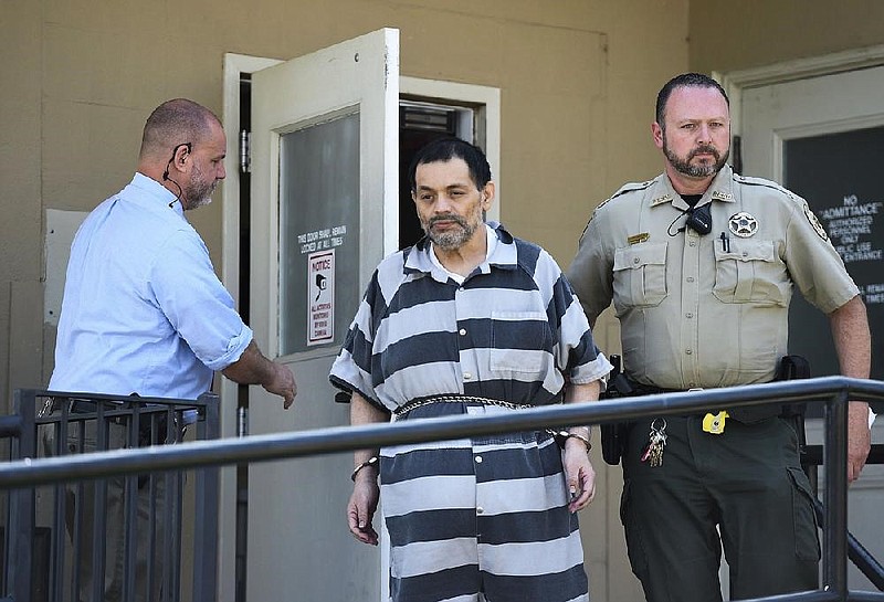 Mauricio Alejandro Torres is escorted out of the Benton County Courthouse Annex on in Bentonville in this June 22, 2019 file photo.