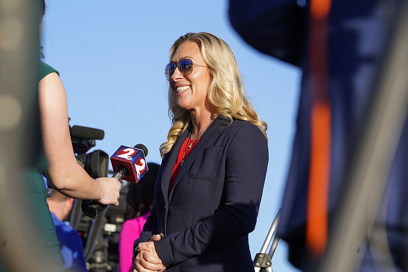 Rep. Marjorie Taylor Greene, R-Ga., is interviewed before former President Donald Trump speaks at a rally in support of the campaign of Ohio Senate candidate JD Vance at Wright Bros. Aero Inc. at Dayton International Airport on Monday, Nov. 7, 2022, in Vandalia, Ohio. (AP Photo/Michael Conroy)