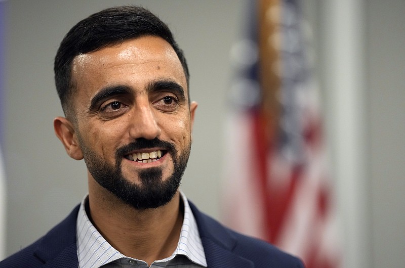 Abdul Wasi Safi smiles after a news conference Friday, Jan. 27, 2023, in Houston. Wasi Safi, an intelligence officer for the Afghan National Security Forces who fled Afghanistan following the withdrawal of U.S. forces, was freed this week and reunited with his brother after spending months in immigration detention. (AP Photo/David J. Phillip)