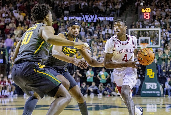 Arkansas guard Davonte Davis (4) looks to drive to the basket against multiple Baylor defenders during the first half of an NCAA college basketball game in Waco, Texas, Saturday, Jan. 28, 2023. (AP Photo/Gareth Patterson) Arkansas guard Davonte Davis (4) looks to drive to the basket against multiple Baylor defenders during the first half of an NCAA college basketball game in Waco, Texas, Saturday, Jan. 28, 2023. (AP Photo/Gareth Patterson)