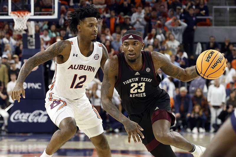 Texas A&M guard Tyrece Radford (23) drives to the basket around Auburn guard Zep Jasper (12) during the first half of an NCAA college basketball game Wednesday, Jan. 25, 2023, in Auburn, Ala.. (AP Photo/Butch Dill)