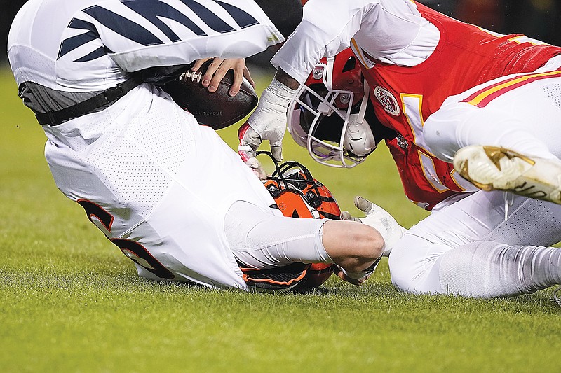 Bengals quarterback Joe Burrow is sacked by Chiefs defensive end Frank Clark during Sunday night's AFC Championship Game at Arrowhead Stadium in Kansas City. (Associated Press)