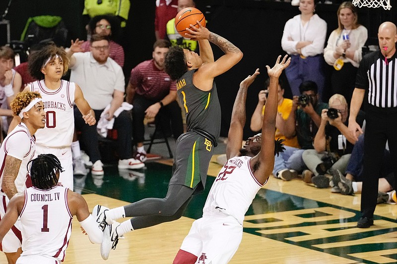 Baylor guard Keyonte George (1) drives to the basket and shoots over Arkansas forward Makhel Mitchell (22) in the first half of an NCAA college basketball game, Saturday, Jan. 28, 2023, in Waco, Texas. (Chris Jones/Waco Tribune-Herald via AP)