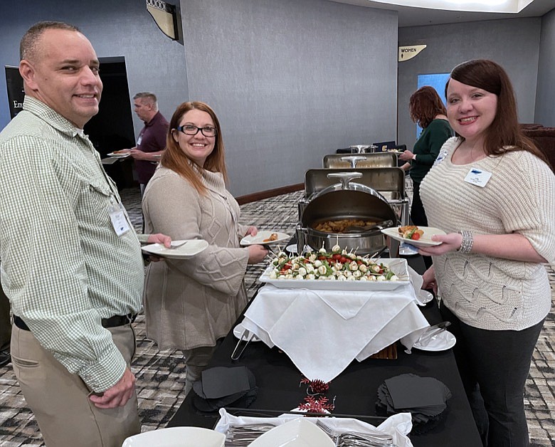 Photography by Jennifer McNally / From left, Brian Atkins, Sarah Pugh and Lisa Atkins attend the Southeast Tennessee SHRM holiday party.