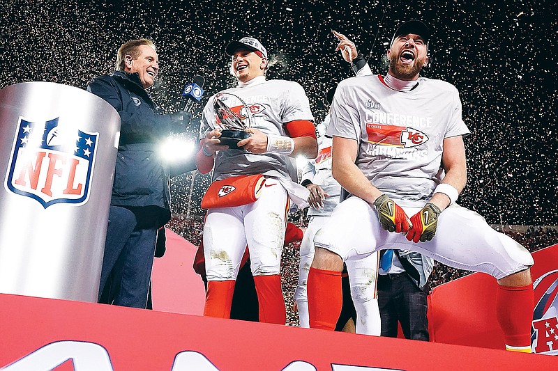 Chiefs quarterback Patrick Mahomes and tight end Travis Kelce celebrate with the Lamar Hunt Trophy after Sunday night’s 23-20 win against the Bengals in the AFC Championship Game at Arrowhead Stadium in Kansas City. (Associated Press)