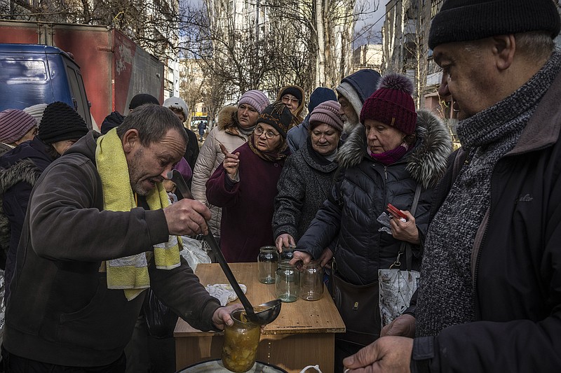 People line up for jars of hot soup Wednesday at a humanitarian aid distribution event in Kherson, Ukraine. The city has been the scene of heavy fighting.
(The New York Times/Ivor Prickett)