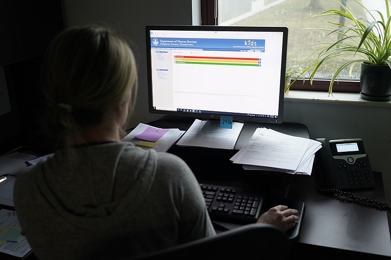 Case work supervisor Jessie Schemm looks over the first screen of software used by workers who field calls at an intake call screening center for the Allegheny County Children and Youth Services, in Penn Hills, Pa.(AP Photo/Keith Srakocic, File)