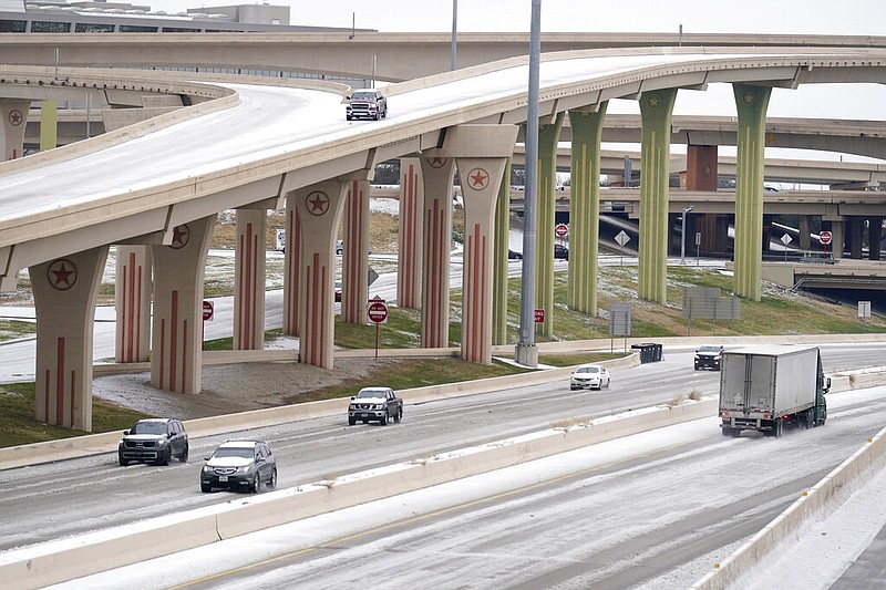 Drivers slowly navigate through icy road conditions at the US 75 highway and LBJ 635 interchange Tuesday, Jan. 31, 2023, in Dallas. (AP/Tony Gutierrez)