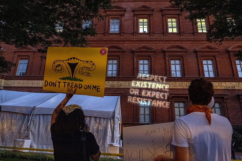 FILE - Abortion-rights protesters project messages to a building during an event sponsored by Susan B. Anthony Pro Life America at the National Building Museum, Sept. 13, 2022, in Washington. Emboldened anti-abortion activists are looking to the next presidential election as an opportunity to solidify their influence over the Republican Party. Leaders of the influential group Susan B. Anthony Pro-Life America are telling potential GOP presidential hopefuls they expect Republican candidates to support national restrictions on the procedure. (AP Photo/Gemunu Amarasinghe, File)