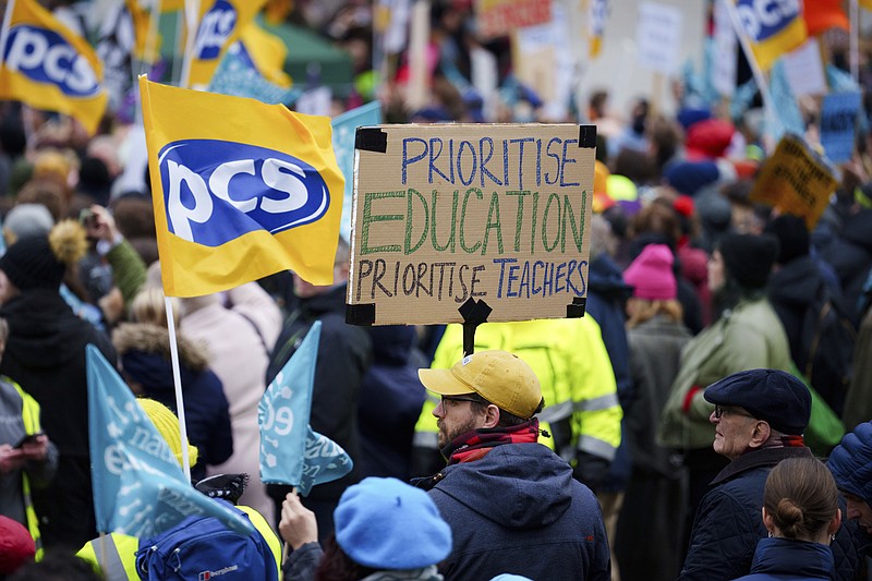 A demonstration in support of strikers is seen in central Manchester, England, Wednesday, Feb. 1, 2023. Thousands of schools in the U.K. closed some or all of their classrooms, train services were paralyzed and delays were expected at airports Wednesday in what’s shaping up to be the biggest day of industrial action Britain has seen in more than a decade, as unions step up pressure on the government to demand better pay amid a cost-of-living crisis.  (AP Photo/Jon Super)