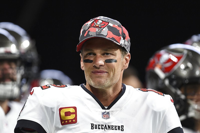 FILE - Tampa Bay Buccaneers quarterback Tom Brady (12) smiles during warmups before an NFL football game, Sunday, Jan. 8, 2023, in Atlanta. Brady, who won a record seven Super Bowls for New England and Tampa, has announced his retirement, Wednesday, Feb. 1, 2023. (AP Photo/Hakim Wright Sr., File)