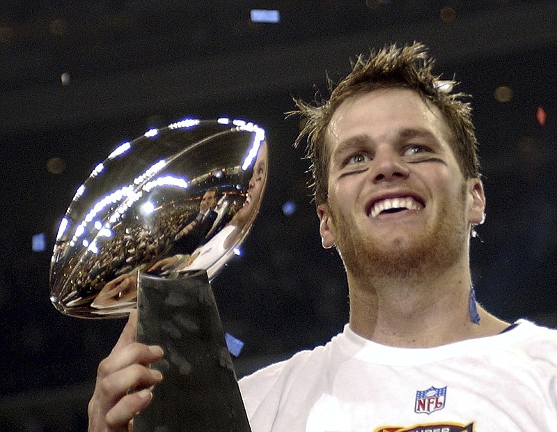 AP photo by Dave Martin / New England Patriots quarterback Tom Brady holds the Vince Lombardi Trophy after his team beat the Carolina Panthers 32-29 in Super Bowl XXXVIII on Feb. 1, 2004, in Houston.